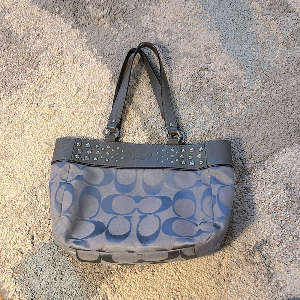 Gray Coach bag with purple lining. Gently used. 11h x 9w x 4w x 2.5. Straps, 19”